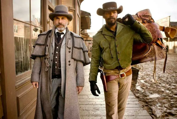 Two men in Western attire standing on a dusty street, showcasing fascinating content from amazing and interesting facts.