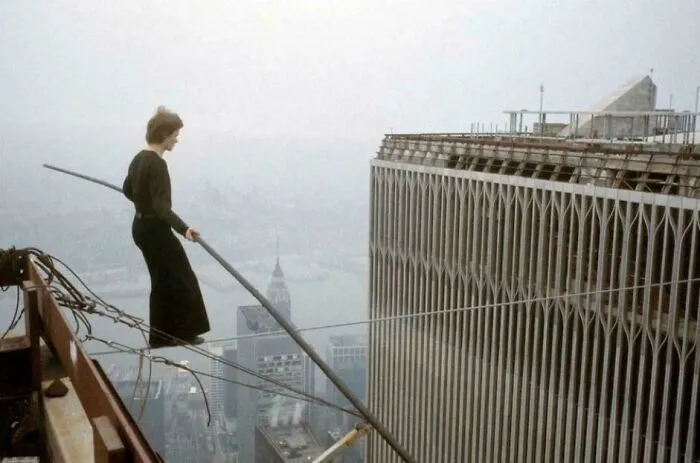 Woman walking on a high wire between skyscrapers, showcasing an amazing and fascinating content about daring feats.