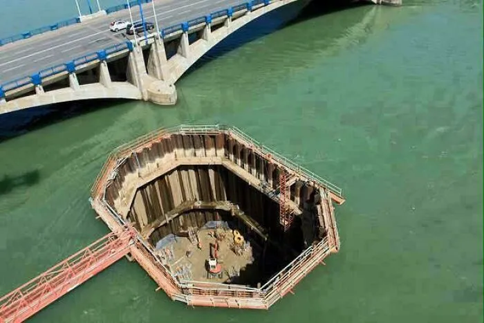 Construction site in water near a bridge, illustrating fascinating content and amazing interesting facts from the internet.