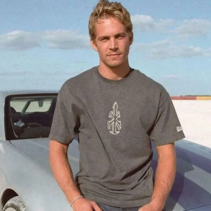 Young man standing by a convertible car on a sunny day, representing fascinating content on the internet.
