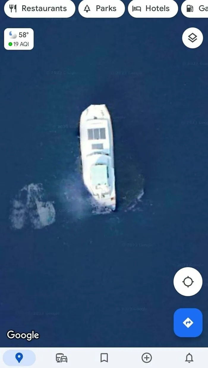 Aerial view of a boat captured on Google Maps, showcasing unexpected shenanigans on the water surface.
