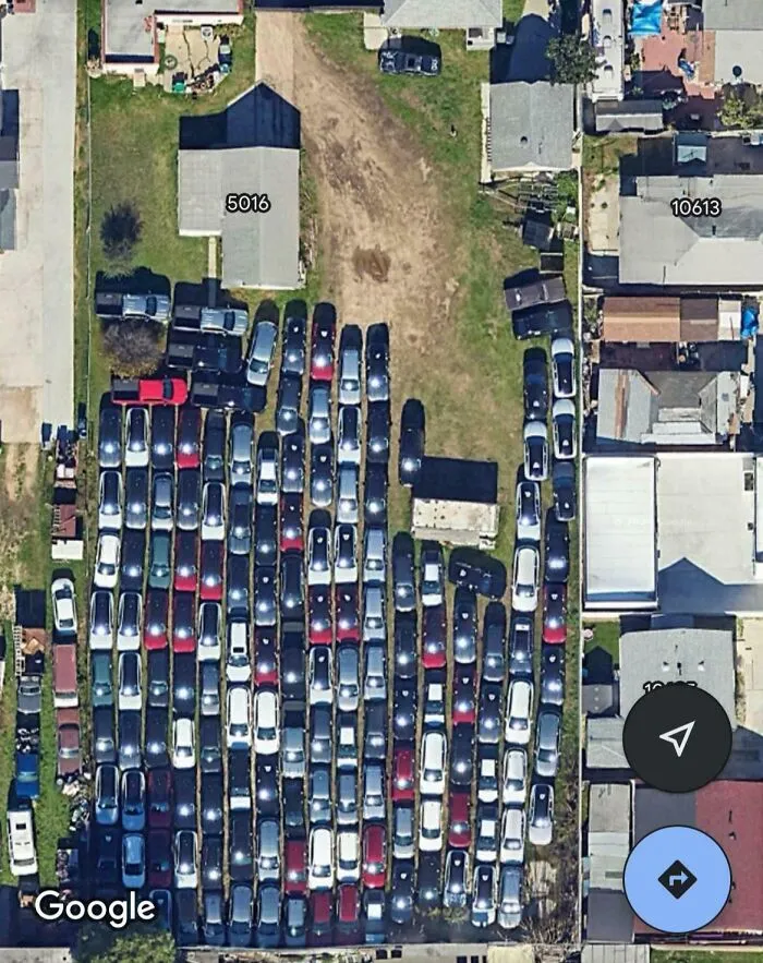 Aerial view of a crowded parking lot showing all sorts of shenanigans captured on Google Maps.