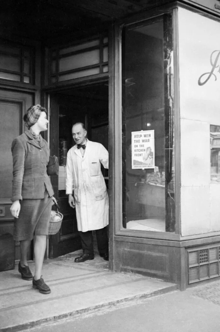 A London Housewife Leaves Her Local Butcher's Shop After Having Bought Her Meat Ration, 1941