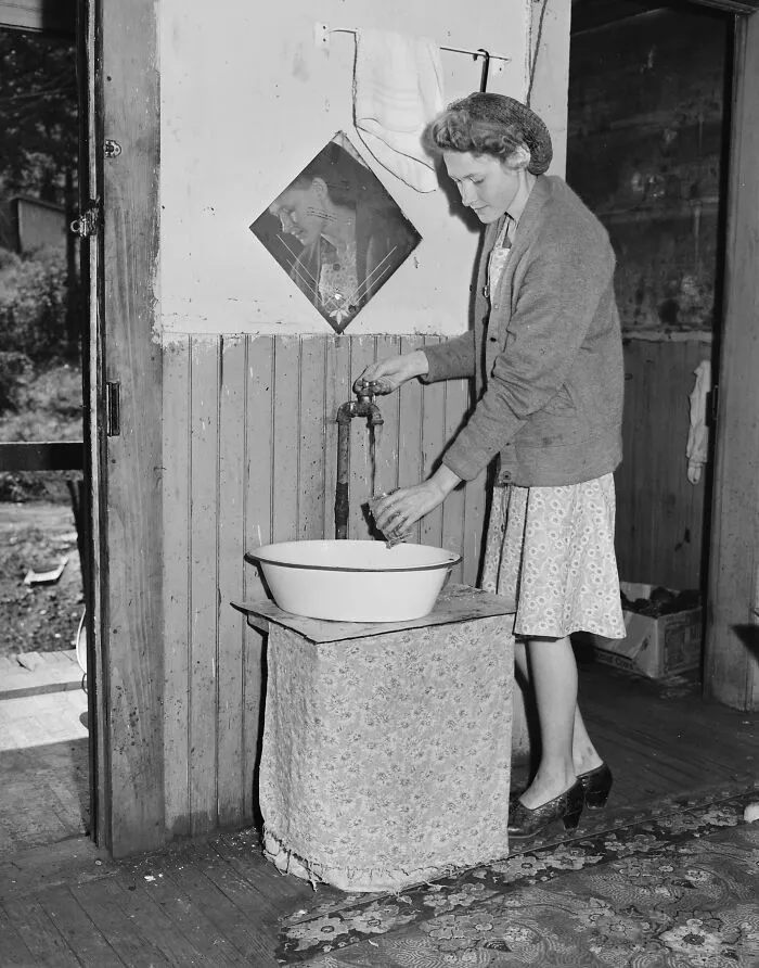 Young Wife Of A Miner Drawing Water At The Tap In Her Kitchen, Wyoming County, West Virginia, 1946