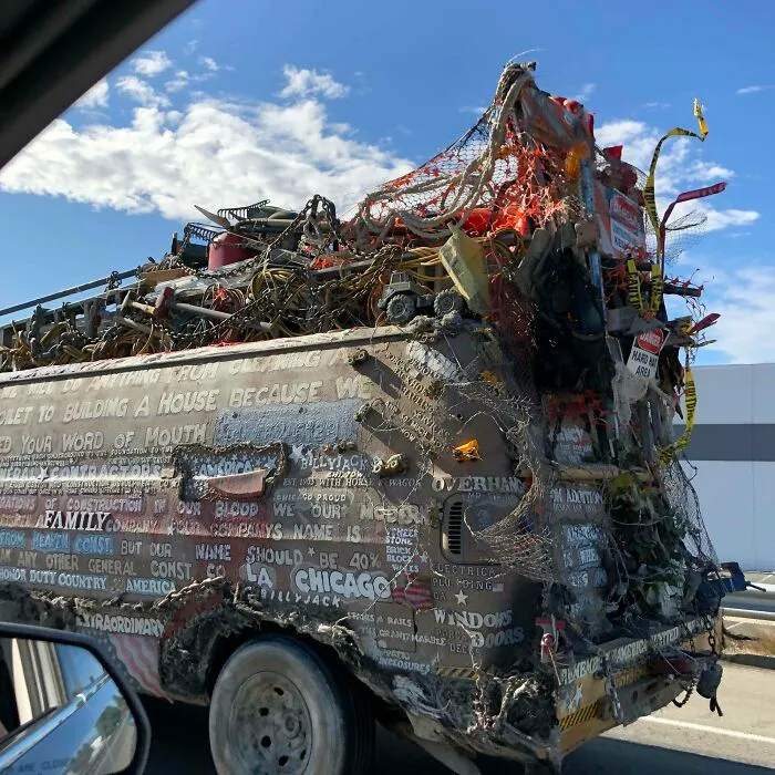 Outrageous car mods featuring an extensively decorated van covered in chains, nets, and various objects on a sunny day.