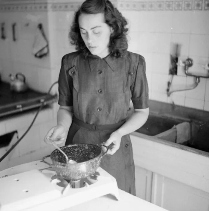 A German Housewife Uses One Of The Finished Helmet Saucepans In Her Kitchen, (1945 - 1975)