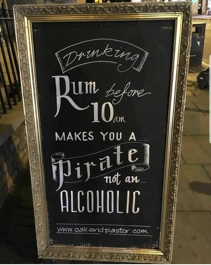 Chalkboard sign with perfect handwriting example stating rum before 10 am makes you a pirate not an alcoholic.