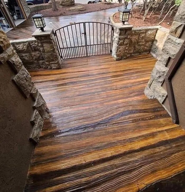 Concrete Steps Stained In Brown And Beige Stripes, Made To Look Like Wood. Stripes Are Parallell With Steps. Unable Identify Number Of Steps