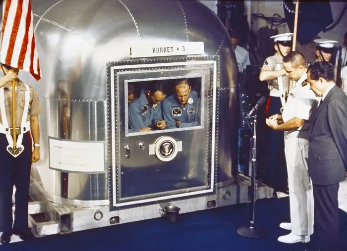 Astronauts In Prayer Within Quarantine Facility