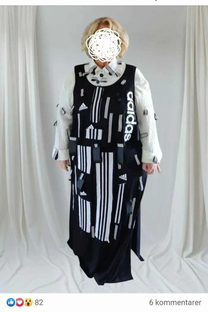 Person wearing a DIY craft shaming outfit made of black and white Adidas fabric scraps with visible tags and patches.