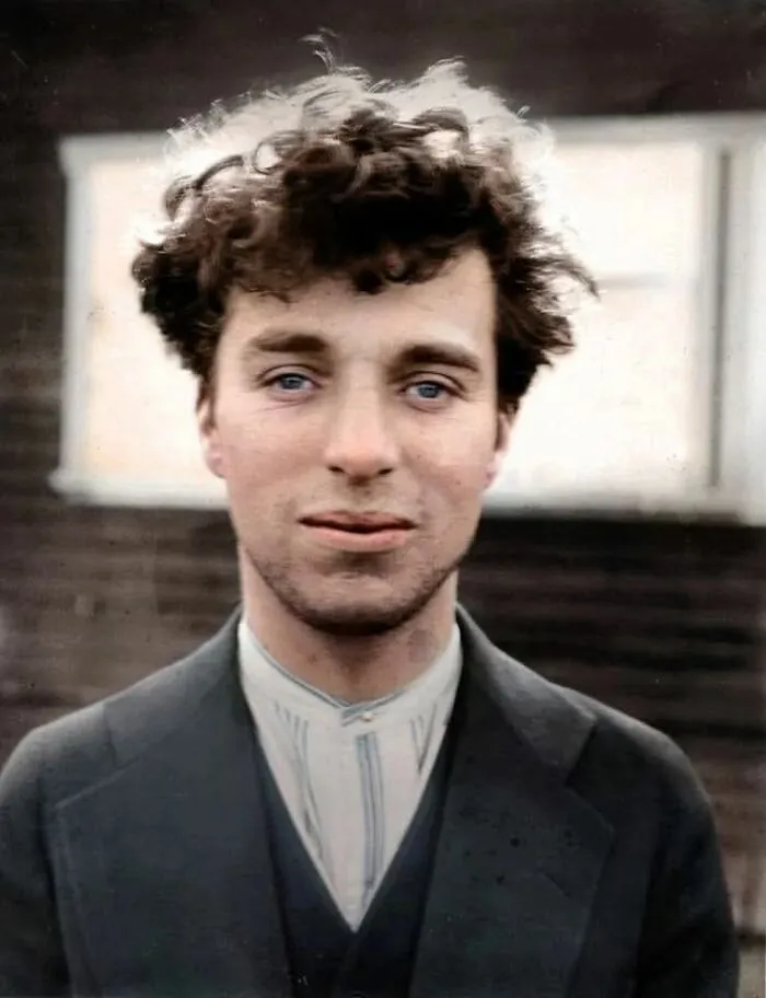 Young man with curly hair in vintage attire, a fascinating historical photo that offers a new perspective on the past.