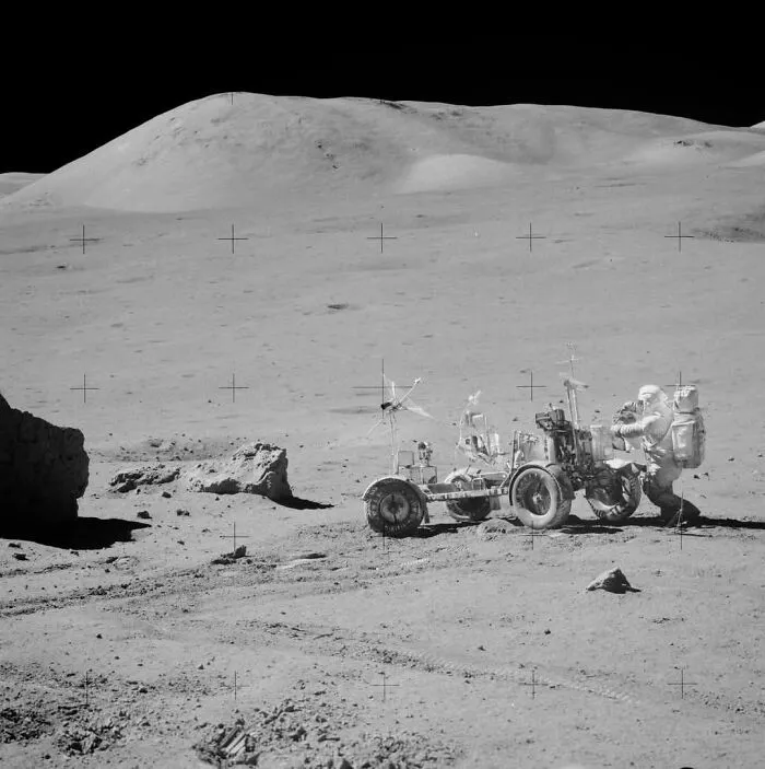 Astronaut with lunar rover on moon surface in one of the fascinating historical photos from space exploration history.