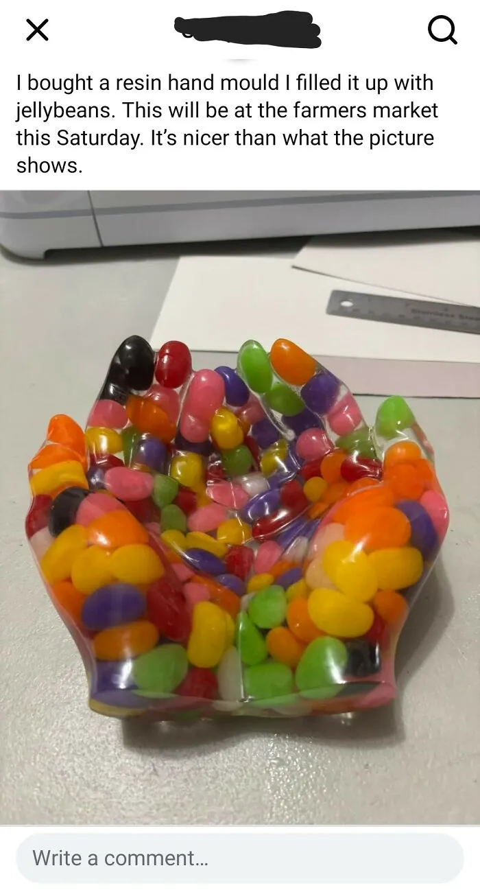 Resin hand mold filled with colorful jellybeans, an unusual and humorous DIY craft project.