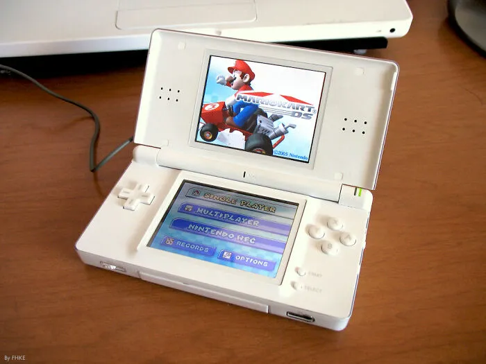 White Nintendo DS displaying Mario Kart DS game menu, capturing nostalgic I was there when it was written moments in gaming history.