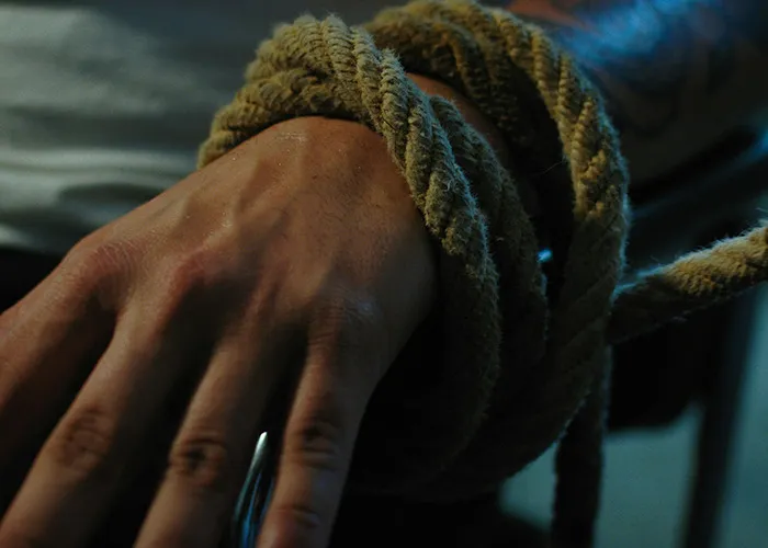 Close-up of a person's hand tied tightly with rope, illustrating unbelievable experiences they can prove.