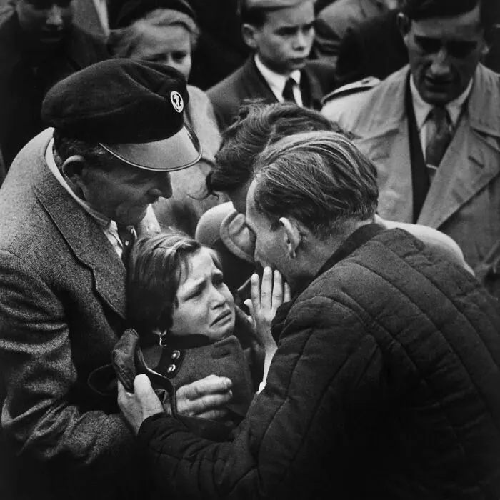 Black and white historical photo showing a distressed child surrounded by men, illustrating weird things about history.