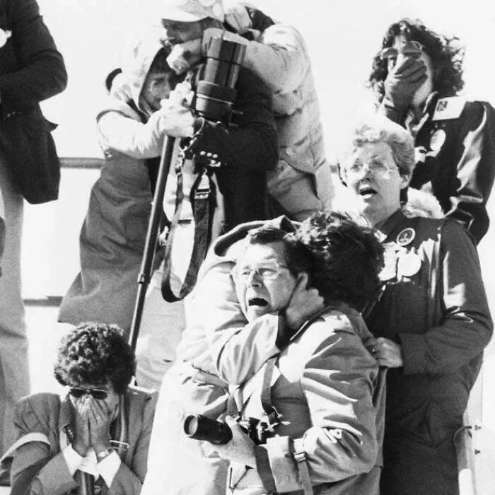 Black and white photo of people reacting with shock and sorrow, illustrating weird things about history.