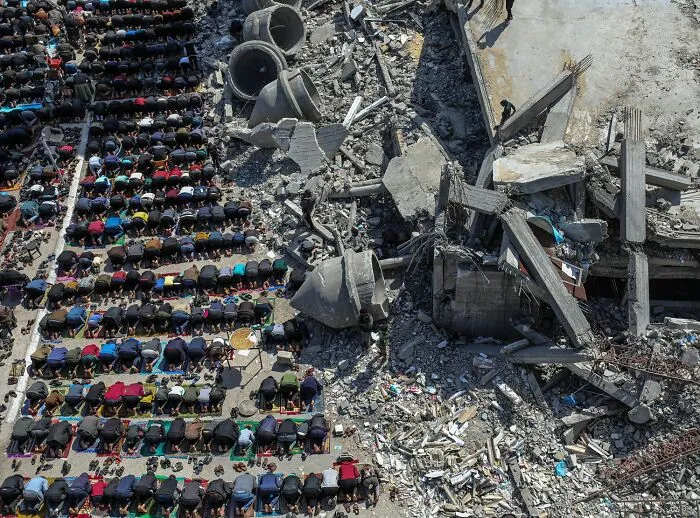 3rd Place Winner: "Unbroken Spirit Worship Amid Destruction" By Abdelrahman Alkahlout, Category: Photojournalism