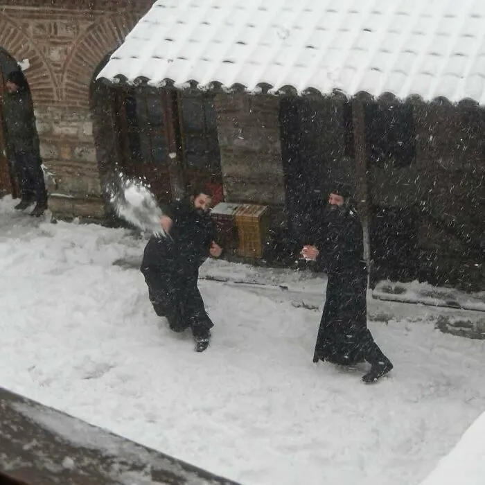 Orthodox Monks Playing In The Snow On Mount Athos, Greece (2015)
