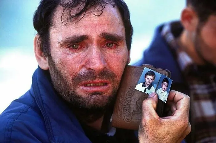 Man with red eyes and beard holding old photos, illustrating weird things about history on an Instagram account.
