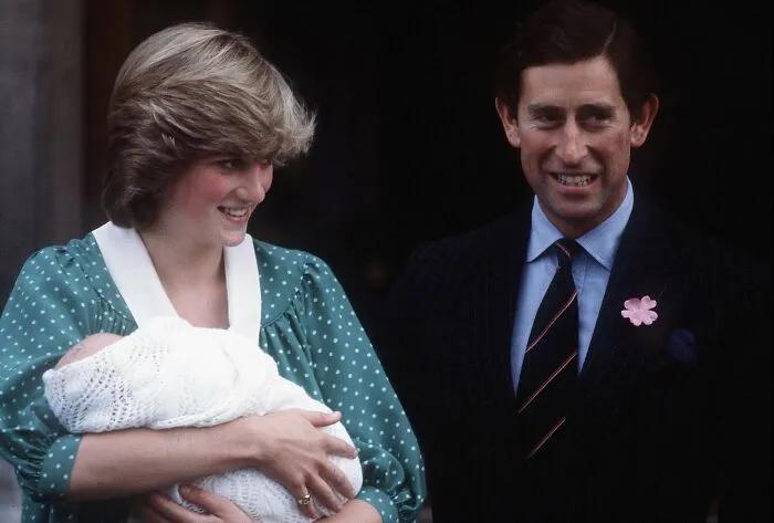Princess Diana holding a newborn baby smiling next to Prince Charles, capturing rare royal family moments and fascinating facts.