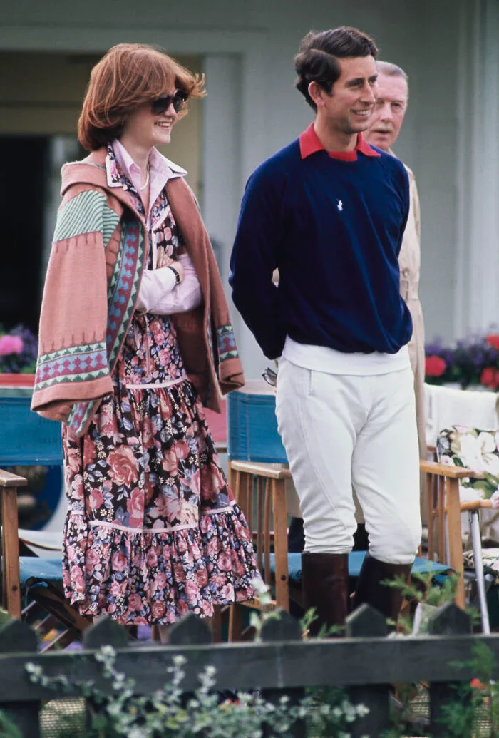 Princess Diana and Prince Charles casually dressed at an outdoor event, showcasing early royal fashion and style.
