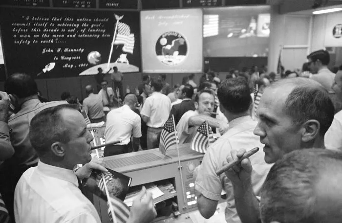 Mission control team celebrating during Apollo mission, capturing iconic moments that still give us goosebumps.