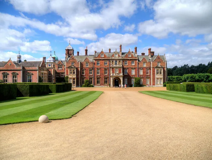 Historic royal estate with manicured gardens under a blue sky, relevant to fascinating facts about Princess Diana.