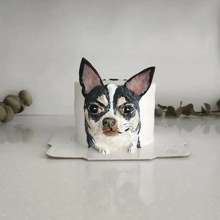 Pet-themed cake shaped and decorated to capture the unique personality of a dog with detailed icing features.