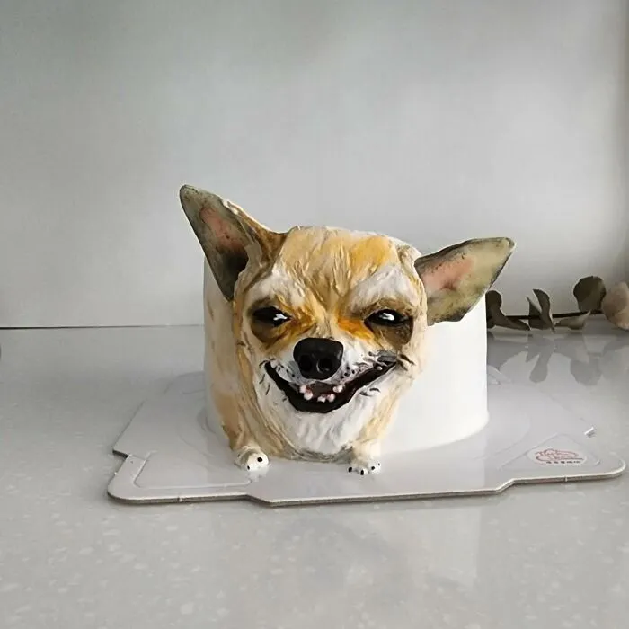 Pet-themed cake shaped like a smiling dog with detailed ears and fur capturing the pet's unique personality.
