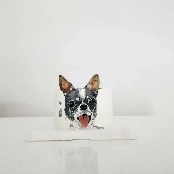 Pet-themed cake shaped like a happy dog with detailed features capturing the unique personality in edible art.