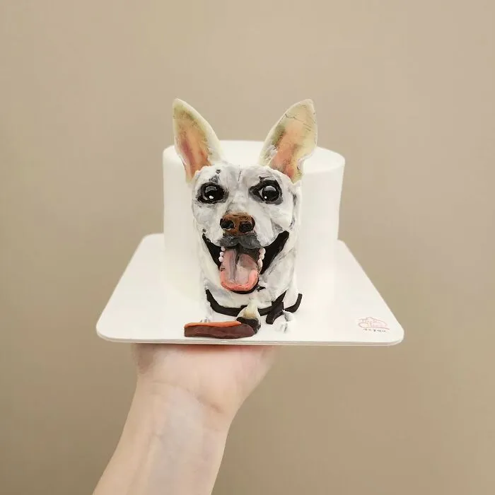 Pet-themed cake featuring a realistic happy dog face with detailed ears and tongue, showcasing unique personality art.