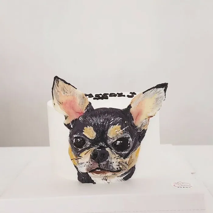 Pet-themed cake featuring a detailed and adorable 3D dog face capturing personality in edible art form.