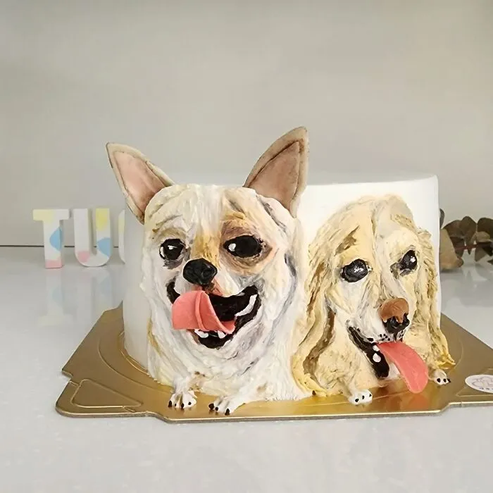Pet-themed cake featuring two dogs with detailed faces and tongues out, showcasing unique personality in adorable design.