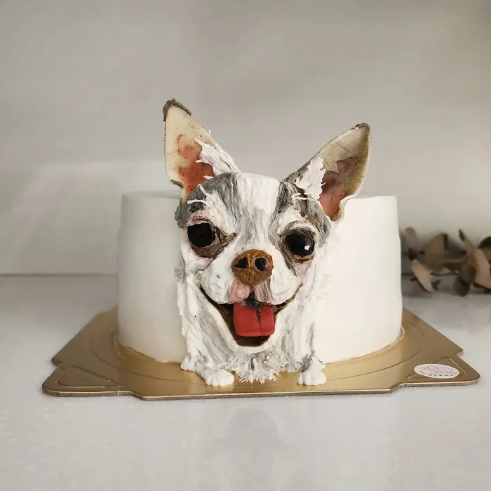 Pet-themed cake shaped like a small dog with detailed frosting capturing the unique personality of the animal.