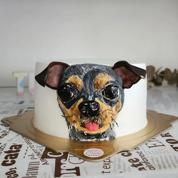 Pet-themed cake shaped like a small dog with detailed frosting capturing the adorable personality of the pet artist designed.