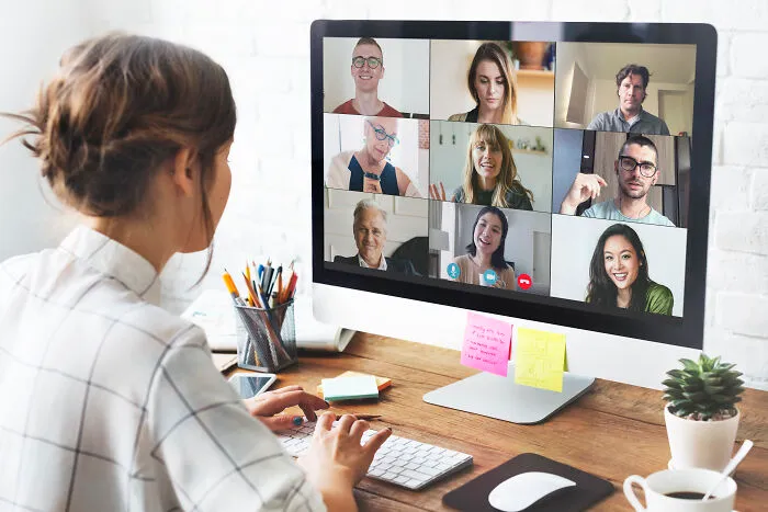 Person on a video call with colleagues, illustrating ways to call out corporate pals' lies politely or rudely.