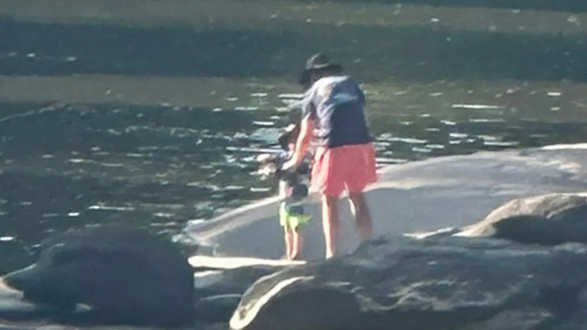 "Makes Me Sick": Photo Of Man And Child Fishing On Seemingly Quiet River Sparks Heated Reactions