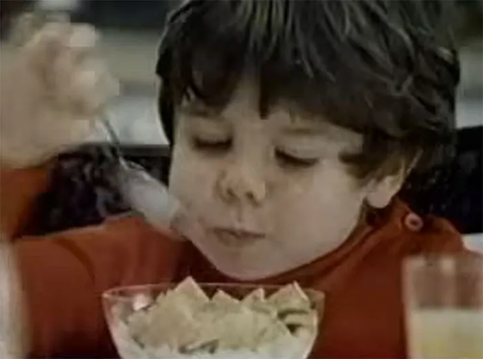 Young boy eating cereal with a spoon, illustrating one of the wildest celebrity rumors circulating online.