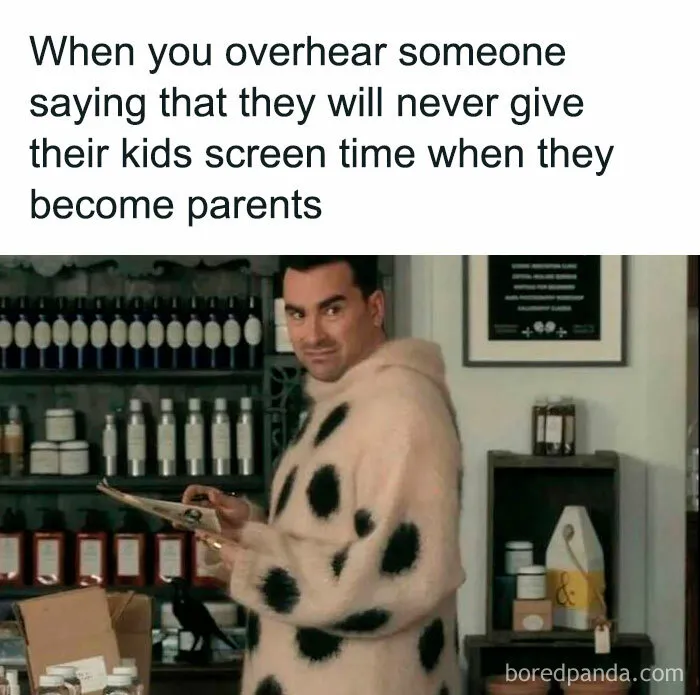 Man in a spotted sweater smirking in a store, illustrating a funny mom post about kids and screen time.