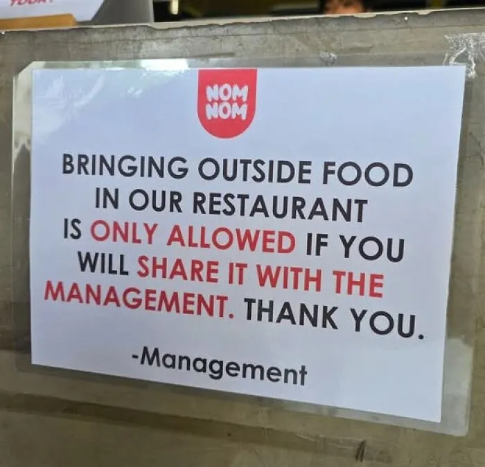 Funny sign at a restaurant about bringing outside food if shared with management adding chaos to the world