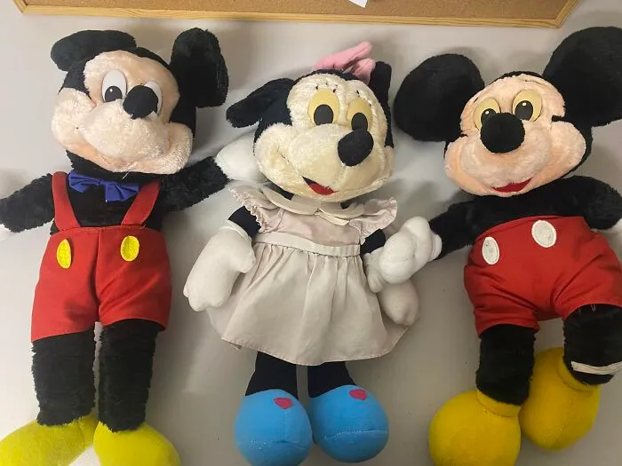 Three vintage stuffed toys resembling classic cartoon characters, representing unexpected things found in walls and hidden places.