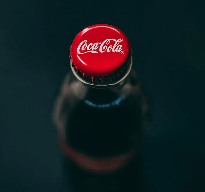 Top view of a glass beverage bottle with a red cap, representing facts to keep the brain active and healthy.