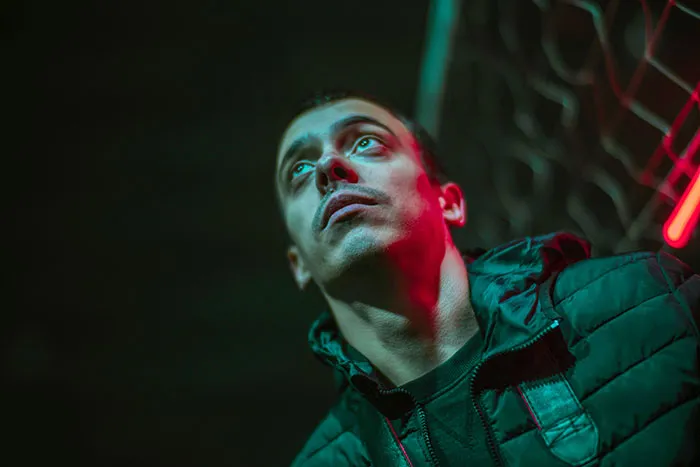Young man in a dark jacket looking upward, conveying emotions related to parents who disowned their children stories.
