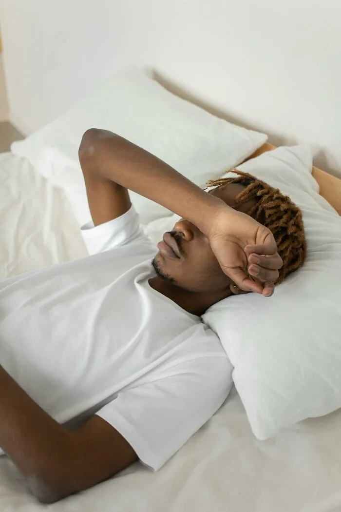 Young man lying in bed looking distressed, depicting intense hospital experiences that resemble a medical drama scene