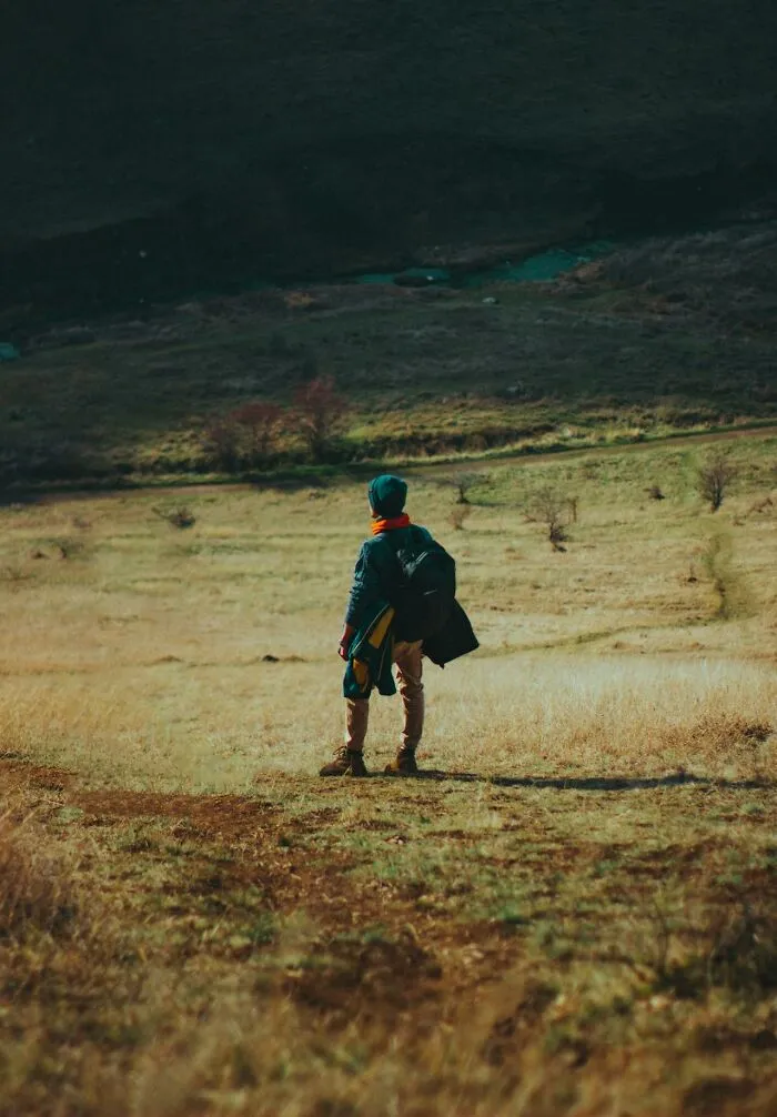 Child exploring open field alone, capturing unique childhood joys before smartphones changed how memories are recorded.
