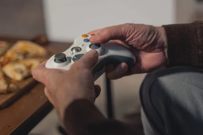Person holding a video game controller, capturing a relatable moment from the best I was there when it was written stories.