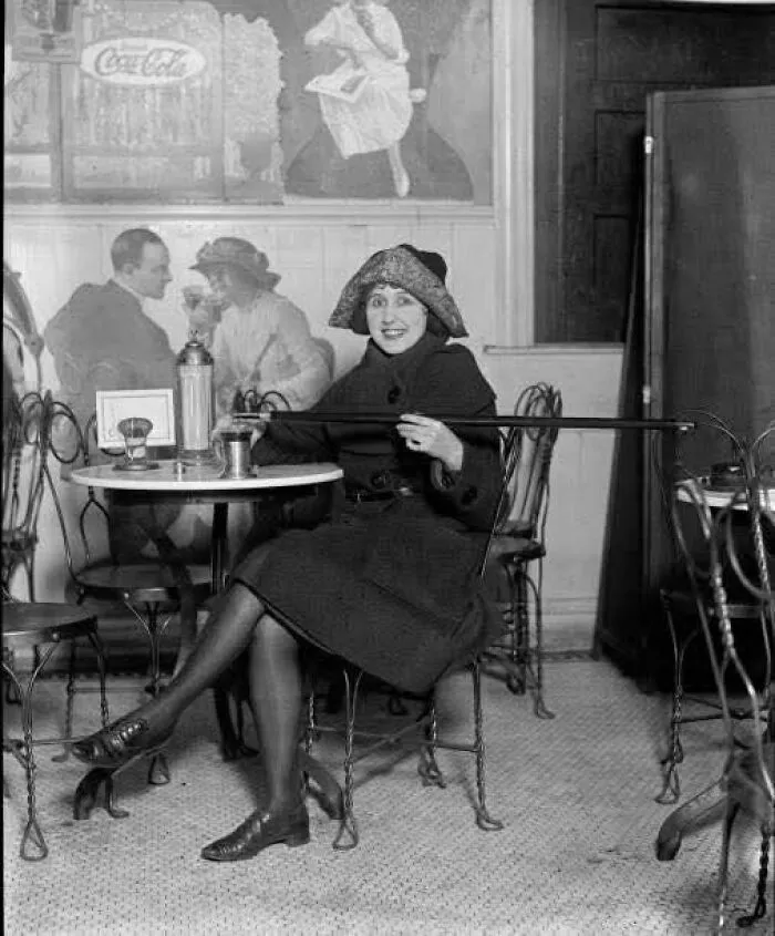 Woman Pours Alcohol From A Cane Into A Cup During Prohibition (1922)