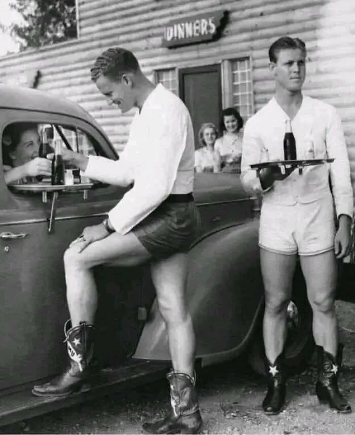 In Texas, During The 1940s, Men Dressed In Shorts And Cowboy Boots Attended To Women At A Drive-In