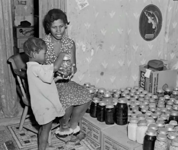A Mother And Daughter Prepare For Winter With Canned Fruits And Vegetables In Saint Mary's County, Maryland (1940)